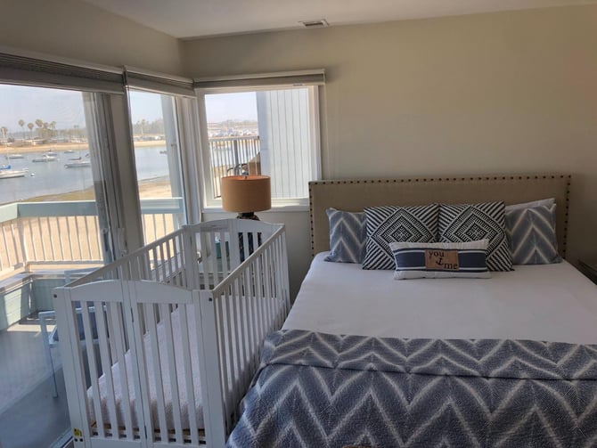 Crib next to bed in bedroom
